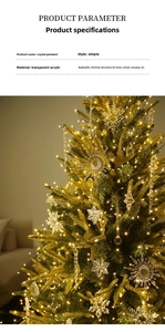 Macro detail of acrylic crystal snowflake ornaments hanging on a lit Christmas tree