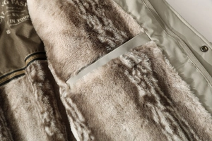 Macro detail of men winter parka featuring thick faux fur lining and metal zipper closure