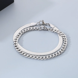 Detail of silver titanium steel snake and cuban chain bracelets with lobster clasps