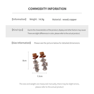 Detailed spec sheet showing 8cm long wood and copper ethnic tassel earrings weighing 14.9g