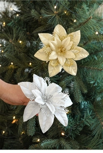 Detail of glitter gold and silver artificial poinsettia flowers for Christmas tree decoration