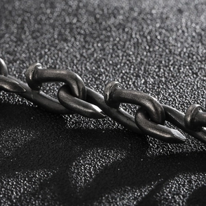 Macro detail of vintage nail-shaped interlocking links in a steel chain bracelet