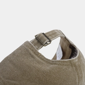 Adjustable back strap of khaki washed cotton baseball cap with vintage bronze buckle closure