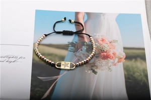 Macro shot of a triple-tone bead star charm bracelet on a fashion magazine background