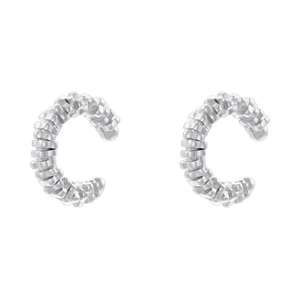 Detail view of silver C-shaped ear cuffs with spiral textured woven metal pattern