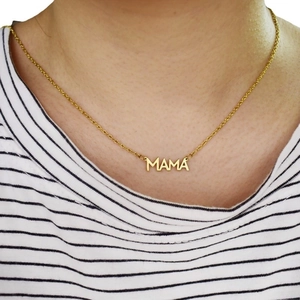 Golden MAMA letter pendant necklace on a delicate chain worn by a female model