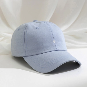 Detailed close-up showing the embroidered white letter S on the light blue twill cotton cap