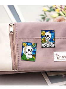 Detail of artistic skull enamel pins with Van Gogh motifs on a purple canvas bag