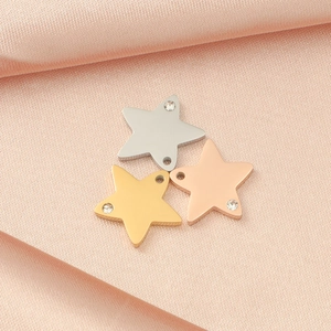 Star-shaped steel pendants in silver, gold, and rose gold with tiny embedded crystals