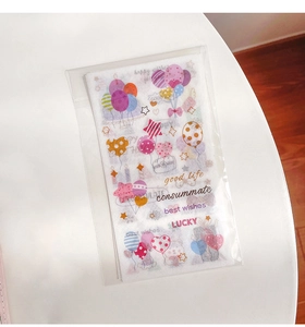 Close-up of colorful cartoon stickers with lucky quotes and shapes in plastic packaging