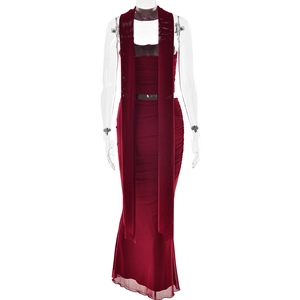 Detail of red tube top set featuring pleated maxi skirt and long matching scarf