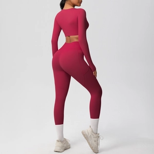 Detail view of burgundy yoga set featuring high-waist leggings and long-sleeve crop top