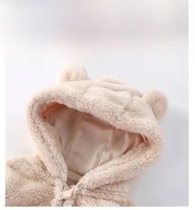 Detail of plush bear hooded jacket showing soft cream fleece texture and cute ears