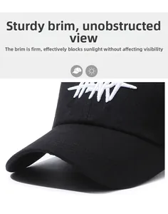 Detailed close-up of a stiff curved brim on a black cotton baseball cap with white embroidery