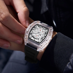 Men's tonneau quartz watch with transparent case and black rubber strap on wrist