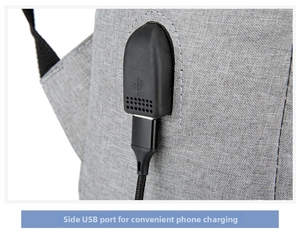 Detailed close-up of side USB charging port on a grey fabric business laptop backpack