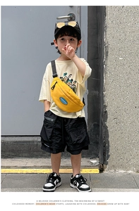 Close-up of bright yellow canvas crossbody chest bag on child streetwear outfit