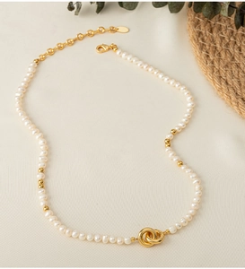 Close-up of pearl choker with golden double loop clasp and adjustable chain
