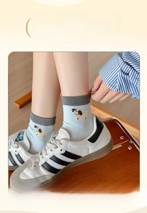 Detail of light blue cartoon dog socks featuring high-elasticity wide ribbed cuffs