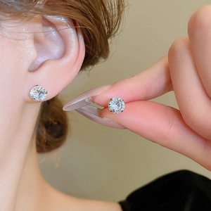 Close-up of polished silver stud earrings featuring round-cut sparkling cubic zirconia