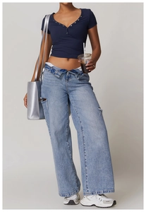 Close-up of navy blue button-up crop top paired with stylish light wash ripped jeans