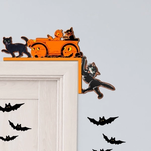 Detail of vintage Halloween wooden door corner decor featuring black cats and pumpkins