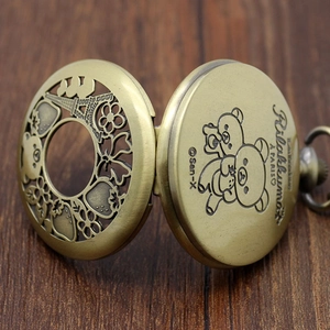 Detailed engraving of Rilakkuma on the inner lid of a vintage bronze pocket watch