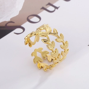 Close-up of golden leaf design adjustable ring with intricate hollow texture