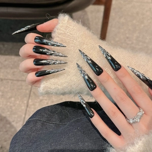 Handmade black stiletto press-on nails with silver 3D metallic flame texture and glitter