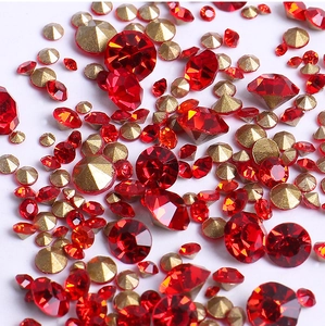 Macro view of sparkling red and gold faceted crystals for 3D nail art decoration