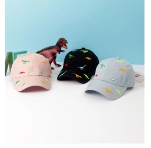 Detailed embroidery of colorful cartoon dinosaurs on various cotton baseball caps