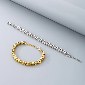 Close-up of stainless steel link bracelets in gold and silver finish with lobster clasp