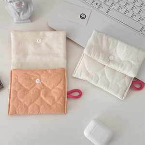 Quilted heart pattern pouches in orange and off-white with snap button closure