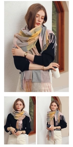 Detailed view of color-block plaid scarf with soft fringe edges in yellow and grey