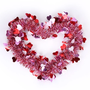 Sparkly red and pink heart-shaped tinsel garland with shiny sequins for Valentine's decor