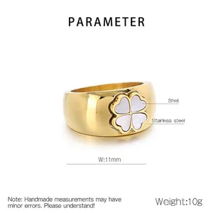 Macro detail of 11mm gold stainless steel ring featuring a white shell clover inlay