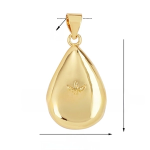 Detailed view of teardrop gold pendant with star engraving and cubic zirconia crystal