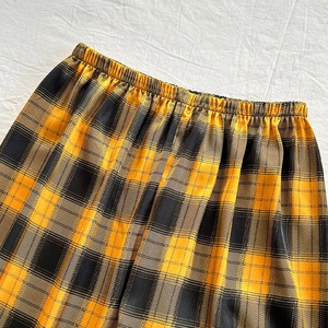Relaxed fit satin lounge pants with classic yellow and black plaid pattern and elastic waist