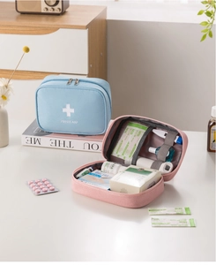 Detail of portable first aid kits with internal mesh pockets and elastic straps for medicine
