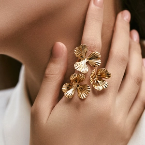 Artistic gold flower ring with three-petal design and textured brushed metallic finish