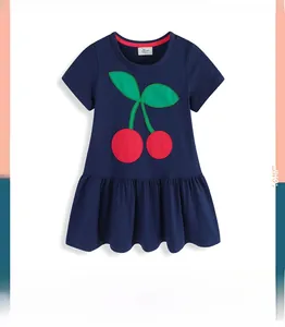 Detail of navy knit dress featuring red cherry embroidery and ruffled hemline