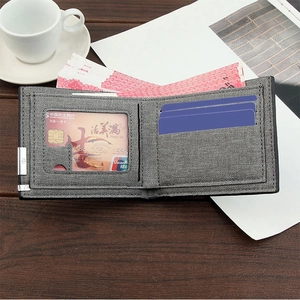 Macro detail of slim gray wallet with multiple card slots and clear ID window on wood