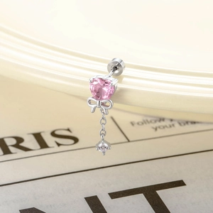 Silver bow heart earring with pink zircon pendant and crystal chain on ceramic plate