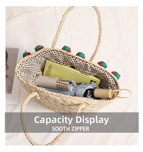 Top view of straw basket bag showing large capacity with books, umbrella and polka dot lining