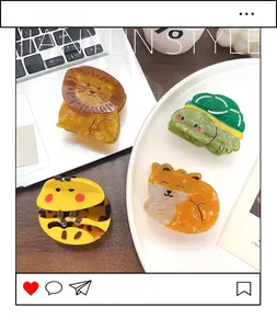 Detail showing acetate hair claws in animal shapes like lion, turtle, bee, and fox