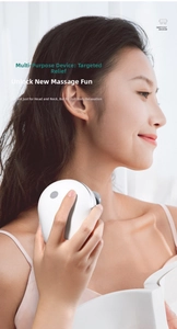 Close-up of a white portable head and scalp massager with ergonomic hand-held design