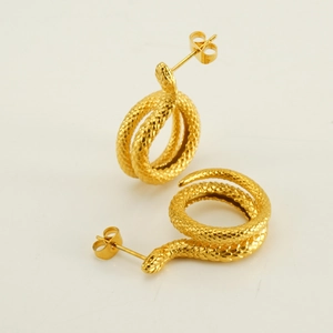 Elegant gold snake earrings with textured scales in a minimalist 45-degree angle view