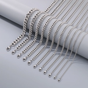 Polished silver stainless steel chain set with various widths on geometric display