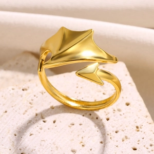 Macro shot of gold adjustable ring with demon wing and arrow details on textured base