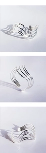 Detailed views of minimalist silver wavy multi-layer open cuff bracelet with metallic finish